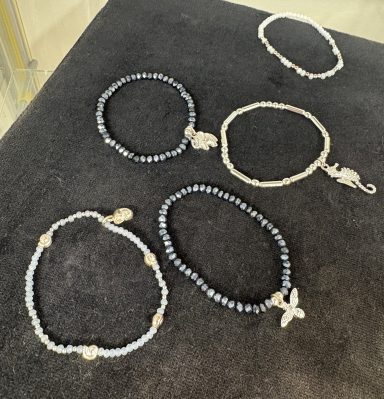 Charmed Braceletes Beaded bracelets in various colours complete with charms.